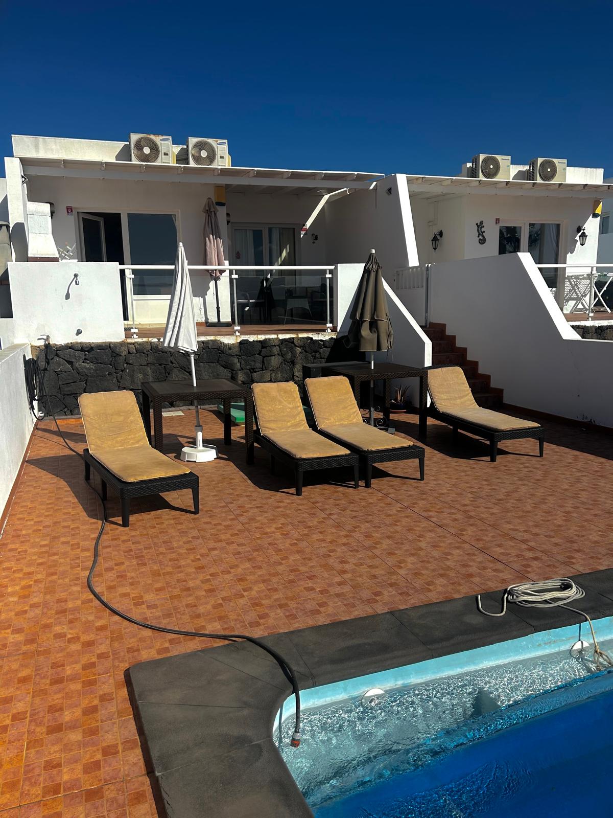 Sun loungers beside the villa